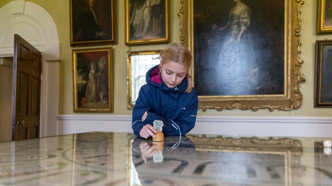 A girl exploring the Drawing Room at Seaton Delaval Hall Northumberland
